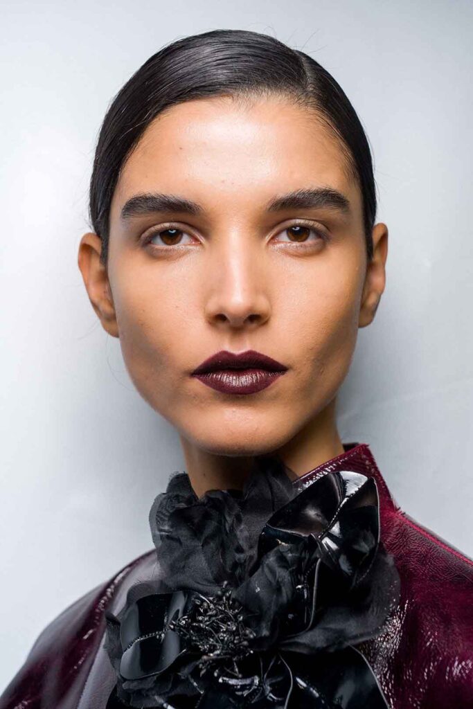 Model Close up mit dunklen, kurzen sleek Haaren und brombeerfarbenem Lippenstift, Kollektion Elie Saab